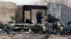 IRAN -- An Iranian police officer stands next to the wreckage after an Ukraine International Airlines Boeing 737-800 carrying 176 people crashed near Imam Khomeini Airport in Tehran, January 8, 2019