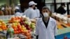 KAZAKHSTAN -- A vendor wearing a protective face mask following an outbreak of the coronavirus disease (COVID-19) waits for customers at a local food market, also known as bazaar, in Almaty, March 20, 2020