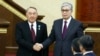 KAZAKHSTAN -- Acting Kazakh President Qasym-Zhomart Toqaev and outgoing Kazakh President Nursultan Nazarbaev shake hands after an inauguration ceremony in Astana, March 20, 2019