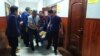 Kazakhstan, Almaty. Gennady Krestyansky being taken out by people in court whose health deteriorated in trial after hunger strike. 24 Sept 2019.