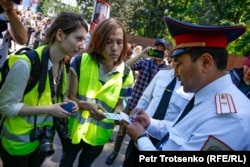 Полицейлер шеру кезінде журналистердің құжатын тексеріп тұр. Ортада тұрған - Vlast.kz басылымының тілшісі Данияр Молдабеков. Алматы, 9 мамыр 2019 жыл.